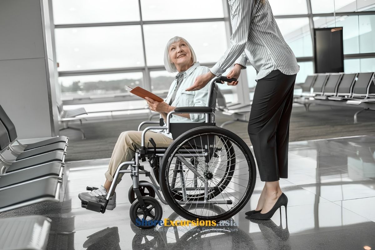 Senior traveler receiving wheelchair assistance at an international airport